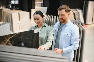 Couple choosing ceramic tiles in hardware store