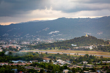 Ko Samui at sunset, Image shows sunset over the small island from the top of a mountain overlooking the airport, runway  and nearby town 