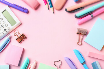 Pens and other stationery on pink background, flat lay. Space for text