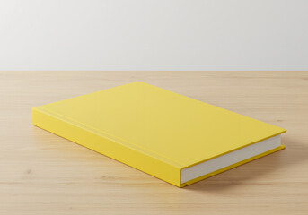 Closed Yellow Hardcover Book Placed on Light Wooden Surface in a Minimalist Composition