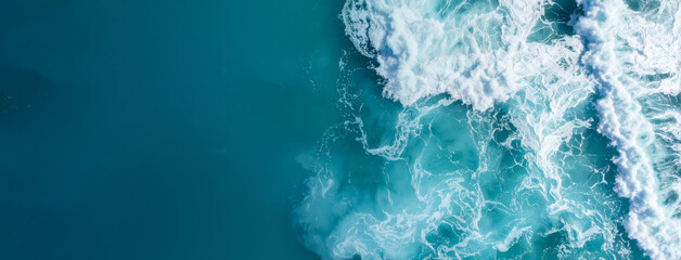 Turquoise ocean waves crashing, creating white foam on a deep blue sea