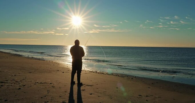 Man throwing fishing line on beach