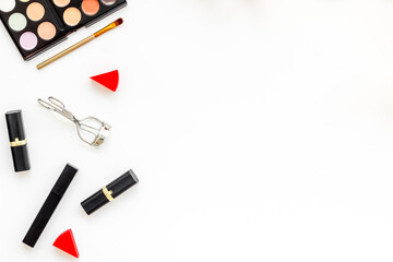 Flatlay of makeup cosmetics on white background. Blusher, mascara and lipstick, top view