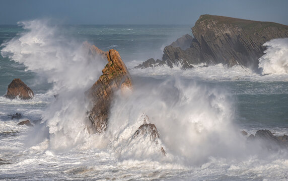 Spain, Liencres. Ocean waves and sea stack formations.