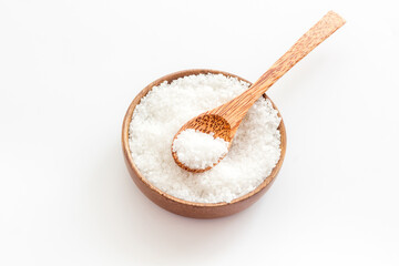 Coarse sea salt in a wooden and spoon Salt for spa, salt baths or cooking