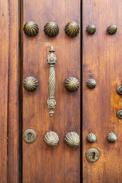 Centro District, Cordoba, Andalusia, Spain. Brass handle and decorations on an old Spanish building.