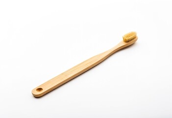 A wooden toothbrush on a white surface.