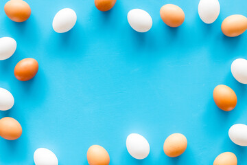 Frame of chicken eggs, top view. Food pattern. Easter background