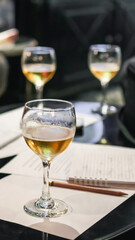 Glass of beer with tasting notes and pencil on table