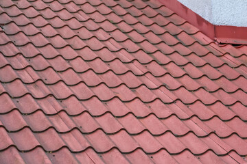 Fototapeta premium Close-up of Red Clay Roof Tiles in Overlapping Pattern Creating Waterproof Home Protection