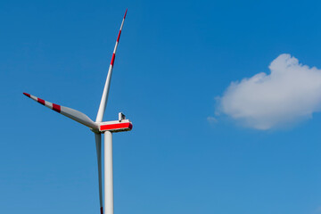 A wind turbine against a blue sky. Wind renewable energy. Production of electric energy..