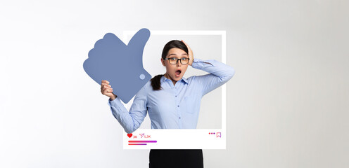 A surprised influencer stands in a studio, holding a large like symbol and expressing excitement....