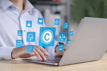 Copyright protection concept. Registration or registration for trademark, Register trademark. Businessman using laptop with copyright icon on virtual screen.