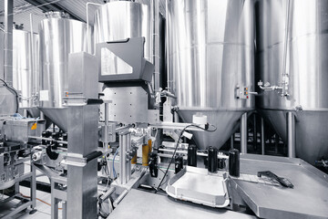 Industrial beer brewery with stainless steel tanks and bottling equipment