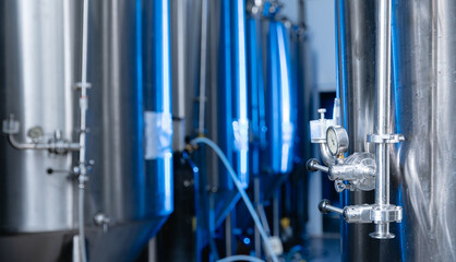 Industrial beer brewery with modern stainless steel fermentation tanks