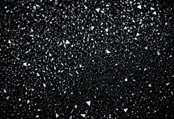 A close up of a bunch of diamonds on a black background.