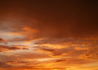 Vibrant orange sky with dramatic sunset clouds in natural gradient
