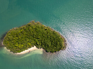 Drone shot of a majestic small Thai island with sailboats around the shore, amazing travel...
