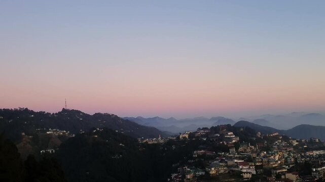 Mussoorie forest Uttarakhand winter lineis visible on the western horizon in the evening from midOctober to January. Sun sets, shades of yellow, red, orange, purple.