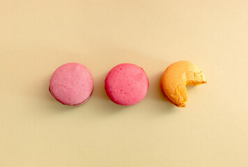 Macaroons on beige background. Flat lay.