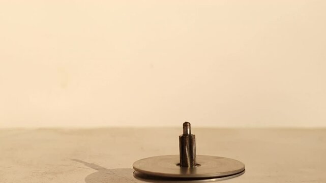 Top spinning iron a rounding string also called lattoo in india. Its a kids game rounding fast.