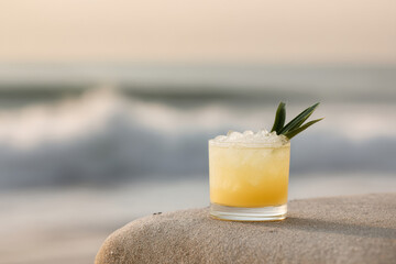 refreshing lemonade cocktail placed on serene surface by beach with gentle waves in background