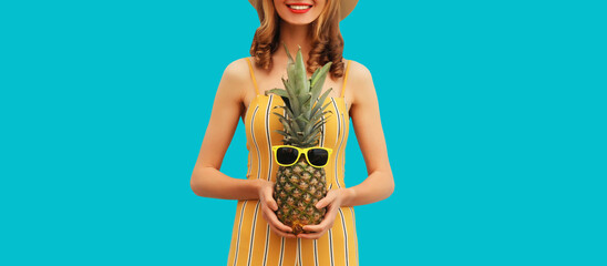 Summer vacation, happy joyful young woman with pineapple fruit, cheerful girl on blue background