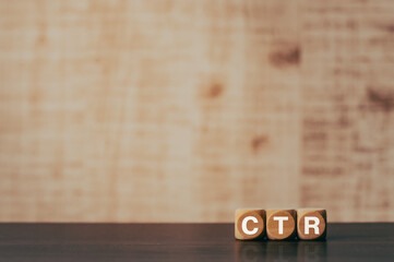 There is wood cube with the word CTR. It is an abbreviation for Click Through Rate as eye-catching...