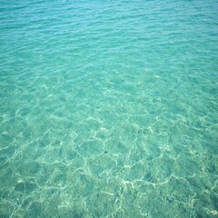 Tranquil coastal waters with rippling sand patterns in cinematic teal tones creating a serene and peaceful underwater scene