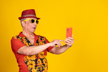 Tourist using smartphone on vibrant yellow background