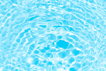 Blue water with ripples on the surface. Defocus blurred transparent blue colored clear calm water surface texture with splashes and bubbles. Water waves with shining pattern texture background.