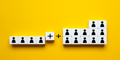 Teamwork concept with two puzzle cubes joining people icons showing unity hiring and cooperation