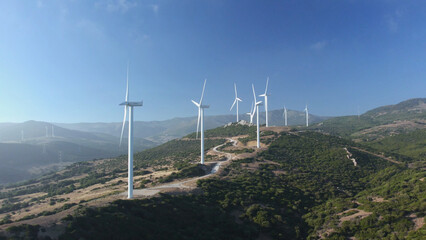 Drone aerial view of wind turbines create electricity close-up. Clean eco renewable green energy concept. Sustainable development. Windmill blades rotate produce power. Alternative eco-friendly farm.