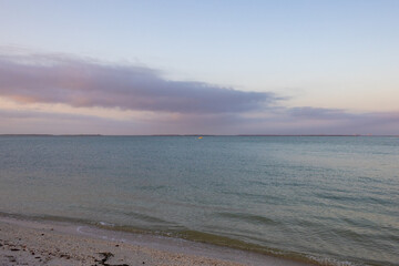 yellow boat on the water at sunset 