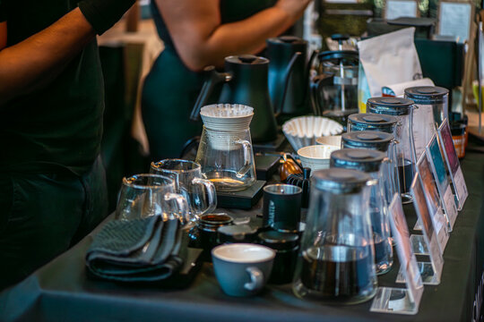 A lively scene from a coffee festival in Copenhagen, featuring baristas at work, diverse coffee cups, engaged customers, brewing techniques, and the rich culture surrounding coffee.