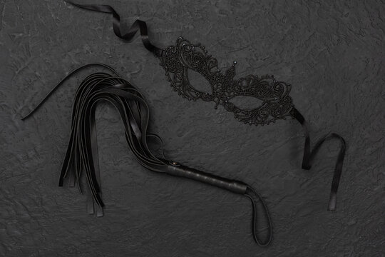 Set of erotic BDSM accessories on concrete background, top view