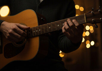 Fototapeta premium Playing Acoustic Guitar with Bokeh Lights in Background