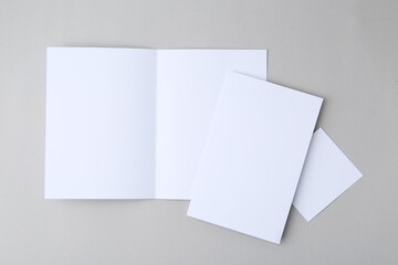 Blank greeting cards on light background, top view