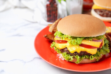 Tasty cheeseburger on white marble table, closeup. Space for text