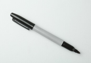 One black marker on light background, top view. Space for text