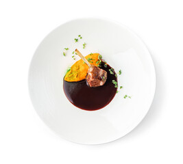 Roasted lamb chops or beef ribs meat with vegetable puree and sauce in plate isolated on white background. Meat dishes, top view, close up