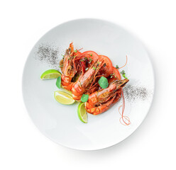 Roasted shrimps with tomatoes and lime decorated with microgreens on plate isolated on white background. Fish and seafood, close up, top view