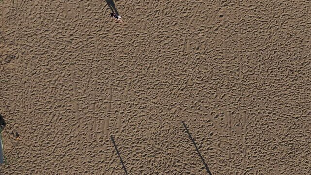 Aerial view of two people walking on the sand of Algodones Beach in San Carlos