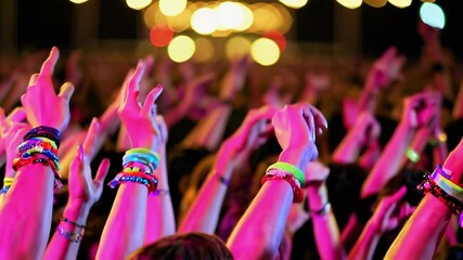 Colorful neon wristband dance party with energetic crowd and festive lights