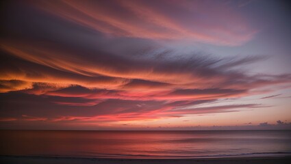 Fototapeta premium A breathtaking sunset over a secluded beach, with the sky and water blending into vibrant hues of orange, pink, and purple