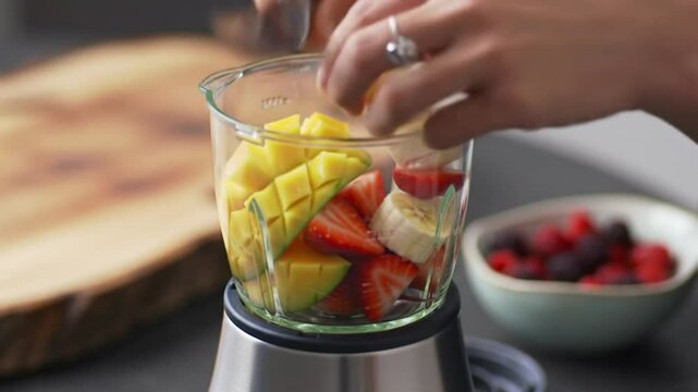 Tropical fruits blending into smoothie