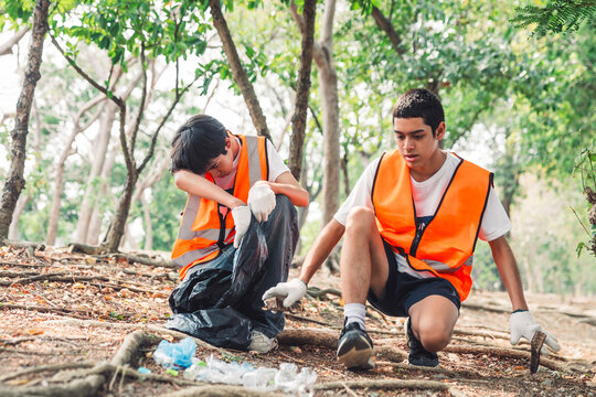 Group of volunteer teenagers work together in a volunteer cleanup to support sustainability, teamwork, and awareness of pollution in the community.