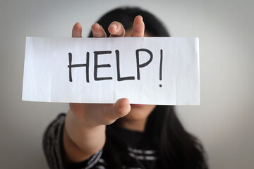 Close Up Of Young Woman Showing A Paper With Written HELP, Stop Human Trafficking