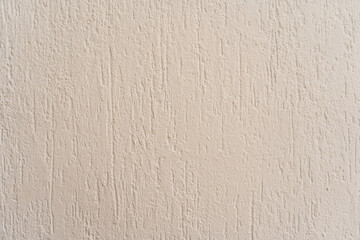Textura de pared beige con acabado estucado vertical - Fondo neutro para diseño arquitectónico y gráfico