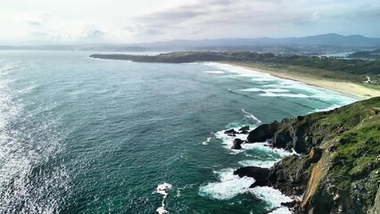 A Breathtaking Aerial View of a Beautiful Coastal Landscape with Waves and Cliffs